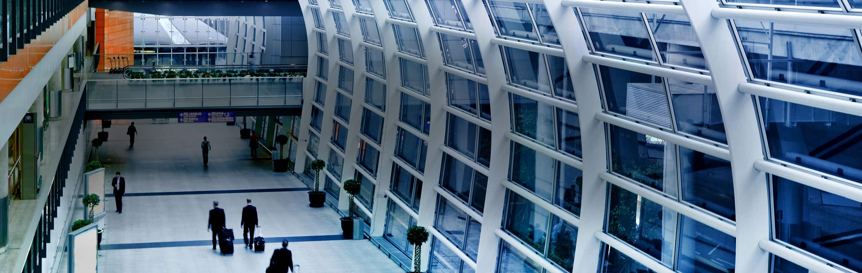 People carrying luggage and walking in an airport